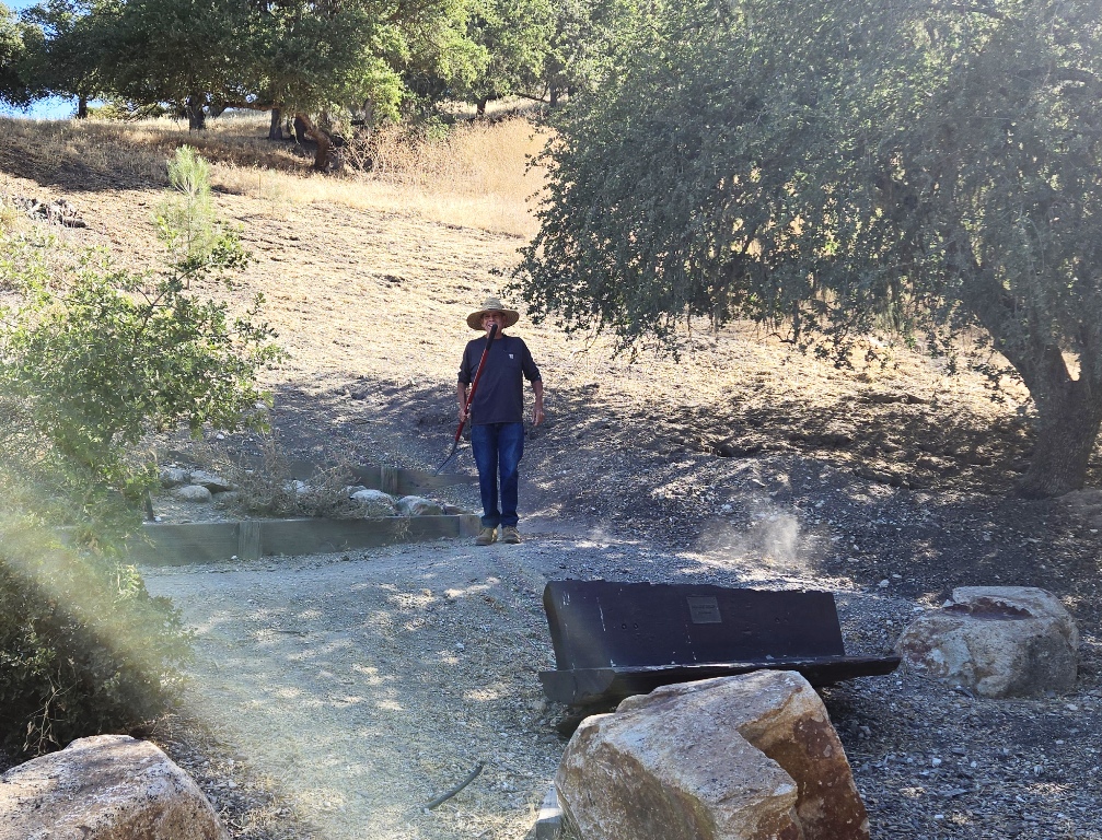 Phil finishing up raking the trail after clean up.
